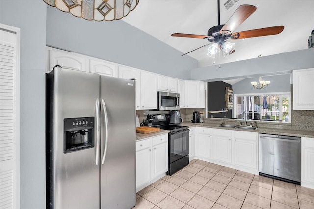 1715 Larabie Ct, Brandon, FL 33511 - kitchen with stainless steel appliances, lofted ceiling, decorative backsplash, light tile patterned floors, and ceiling fan
