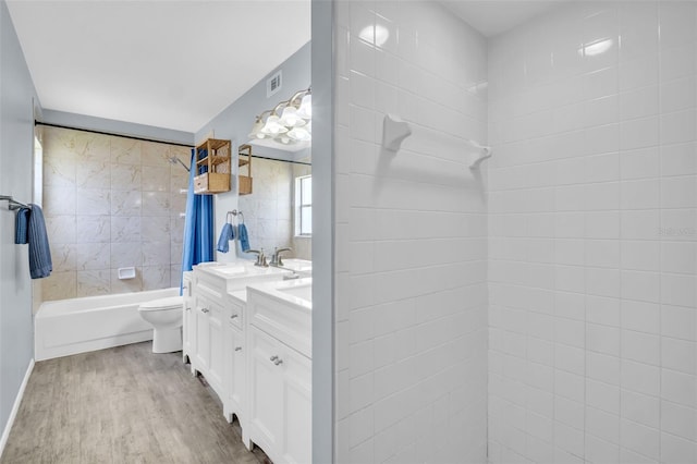 1715 Larabie Ct, Brandon, FL 33511 - bathroom featuring double vanity, shower / bathtub combination, and wood finished floors