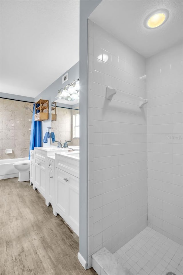 1715 Larabie Ct, Brandon, FL 33511 - bathroom featuring tiled shower, vanity, wood finished floors, and a tub