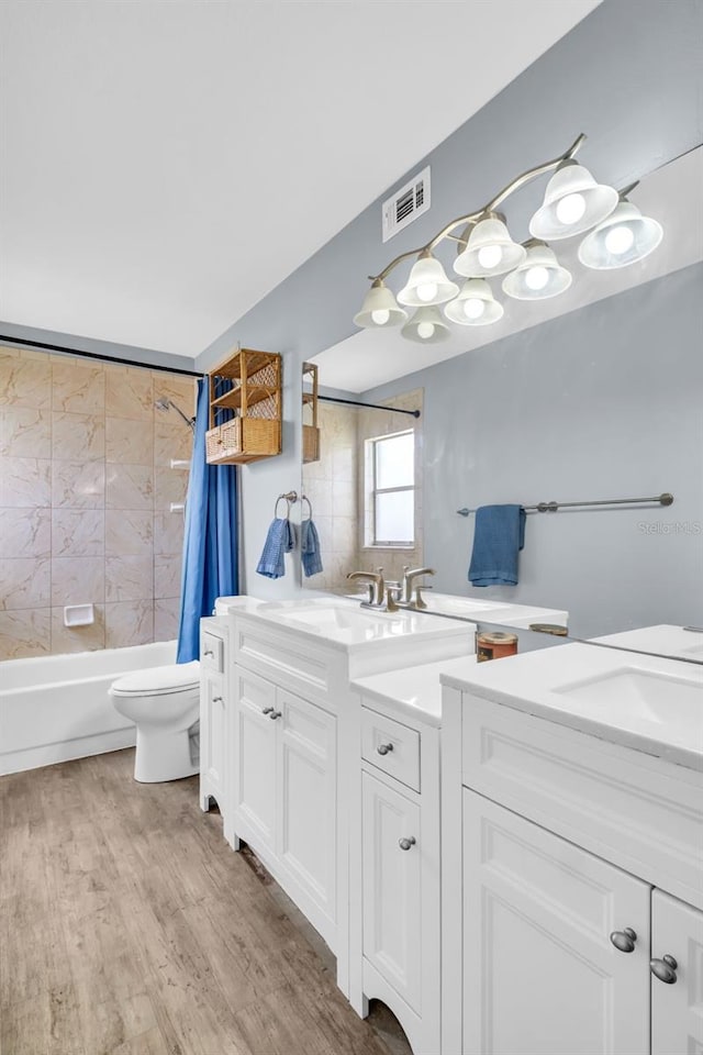 1715 Larabie Ct, Brandon, FL 33511 - bathroom with vanity, shower / tub combo with curtain, and wood finished floors