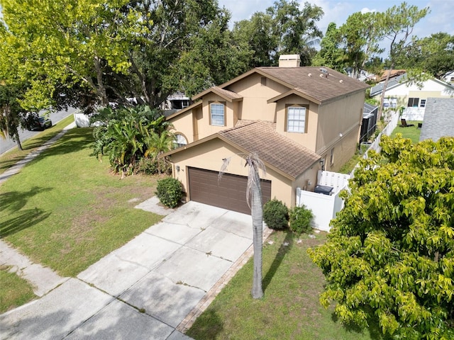 1715 Larabie Ct, Brandon, FL 33511 - view of front facade with stucco siding, a garage, roof with shingles, concrete driveway, and a chimney