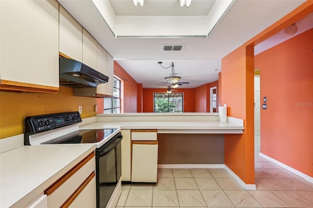 7470 Canterbury St, Spring Hill, FL 34606 - kitchen featuring electric range oven, under cabinet range hood, light countertops, and light marble finish flooring