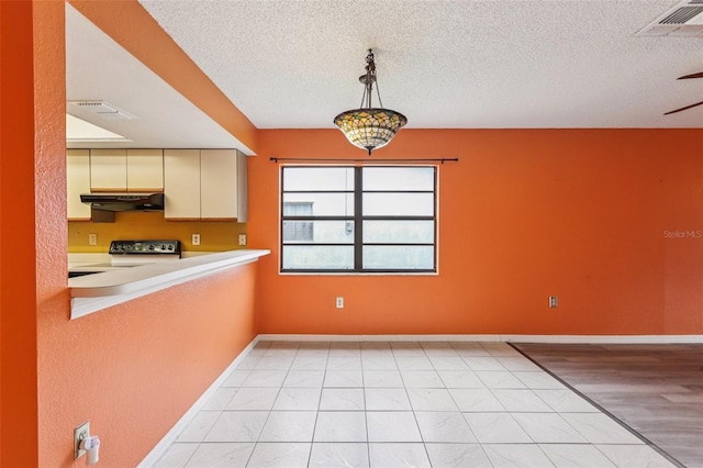 7470 Canterbury St, Spring Hill, FL 34606 - unfurnished dining area with a textured ceiling and baseboards