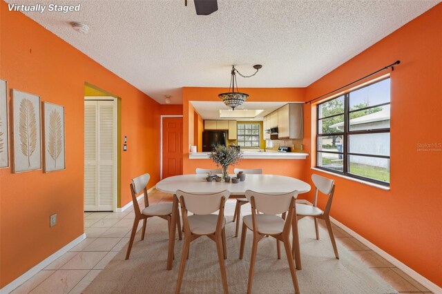7470 Canterbury St, Spring Hill, FL 34606 - dining area with light tile patterned flooring and a textured ceiling