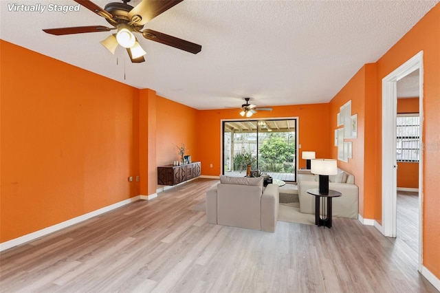 7470 Canterbury St, Spring Hill, FL 34606 - living area with wood finished floors, ceiling fan, and a textured ceiling