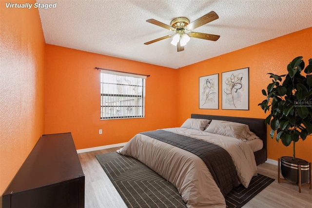 7470 Canterbury St, Spring Hill, FL 34606 - bedroom featuring wood finished floors, a textured ceiling, and ceiling fan
