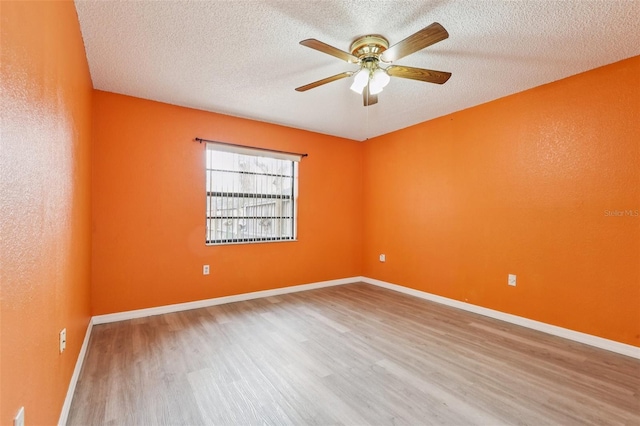 7470 Canterbury St, Spring Hill, FL 34606 - unfurnished room featuring wood finished floors, ceiling fan, and a textured ceiling