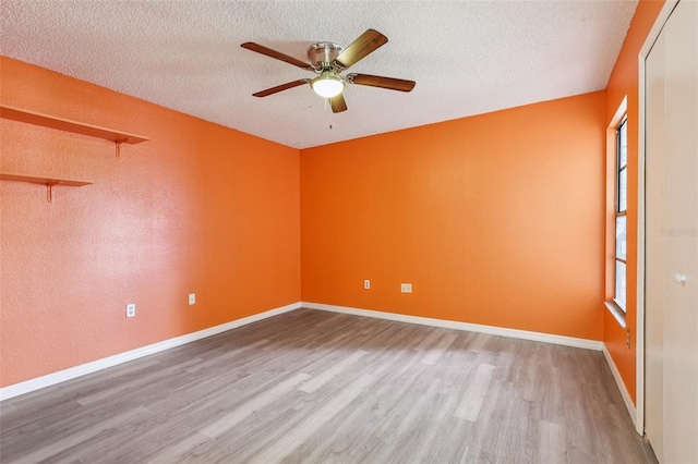 7470 Canterbury St, Spring Hill, FL 34606 - unfurnished room featuring wood finished floors, ceiling fan, and a textured ceiling