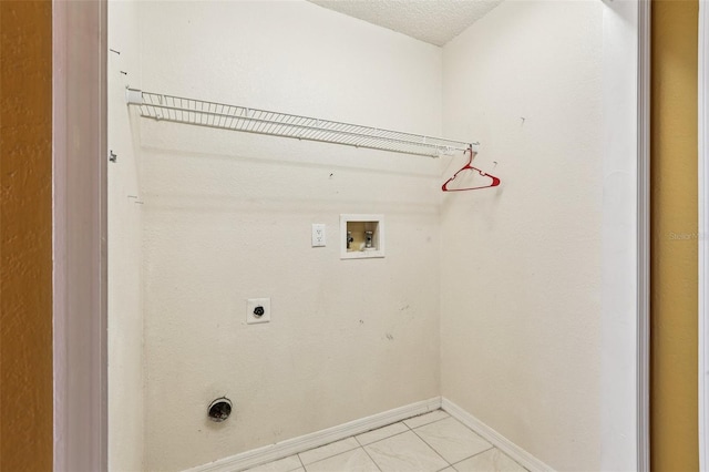 7470 Canterbury St, Spring Hill, FL 34606 - laundry room featuring electric dryer hookup, washer hookup, light tile patterned floors, and a textured ceiling