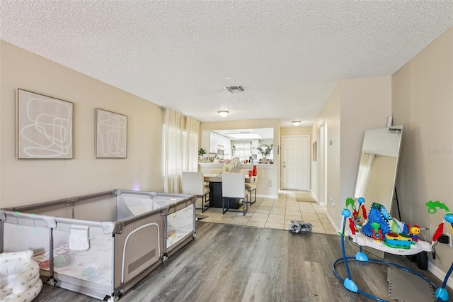 7470 Canterbury St, Spring Hill, FL 34606 - game room with wood finished floors and a textured ceiling