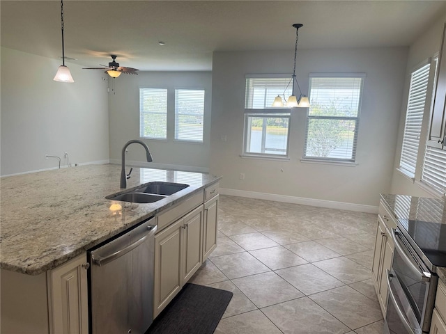 5082 Inshore Landings Dr, Apollo Beach, FL 33572 - kitchen with dishwasher, a ceiling fan, hanging light fixtures, light stone countertops, and an island with sink