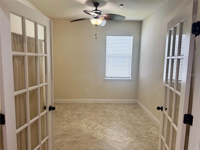 5082 Inshore Landings Dr, Apollo Beach, FL 33572 - unfurnished room featuring french doors, plenty of natural light, a ceiling fan, and a textured ceiling