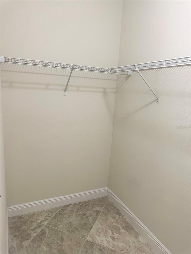 5082 Inshore Landings Dr, Apollo Beach, FL 33572 - walk in closet with light tile patterned flooring