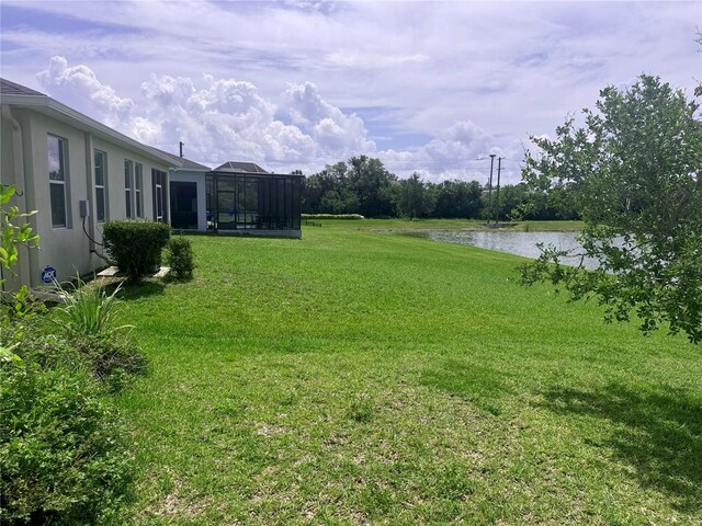 5082 Inshore Landings Dr, Apollo Beach, FL 33572 - view of green lawn featuring a water view and glass enclosure