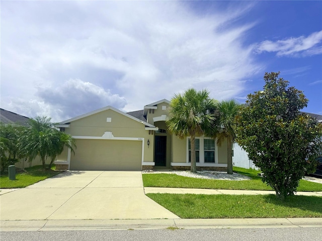 5082 Inshore Landings Dr, Apollo Beach, FL 33572 - view of front facade with an attached garage, driveway, stucco siding, and a front lawn