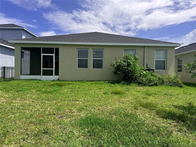 5082 Inshore Landings Dr, Apollo Beach, FL 33572 - rear view of house featuring a sunroom, stucco siding, and a shingled roof