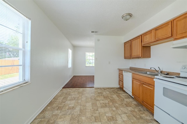 932 W Wheeler Rd, Brandon, FL 33510 - kitchen with white appliances, extractor fan, a textured ceiling, and brown cabinets