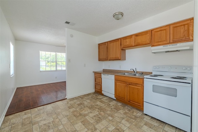 932 W Wheeler Rd, Brandon, FL 33510 - kitchen featuring white appliances, under cabinet range hood, brown cabinets, a textured ceiling, and light countertops