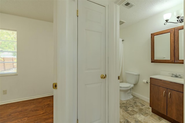 932 W Wheeler Rd, Brandon, FL 33510 - bathroom with vanity, a textured ceiling, and a closet