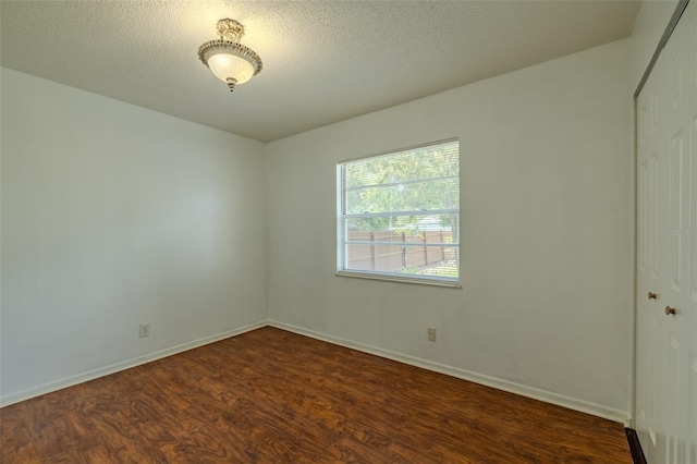 932 W Wheeler Rd, Brandon, FL 33510 - unfurnished room featuring dark wood-style flooring and a textured ceiling