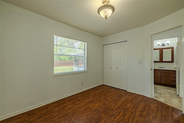 932 W Wheeler Rd, Brandon, FL 33510 - unfurnished bedroom with wood finished floors, a closet, and a chandelier