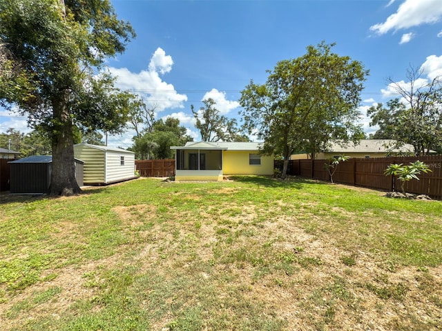 932 W Wheeler Rd, Brandon, FL 33510 - fenced backyard with a storage shed and a sunroom