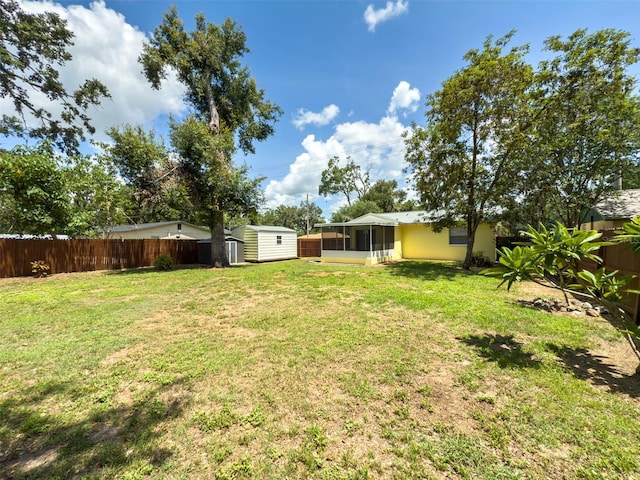 932 W Wheeler Rd, Brandon, FL 33510 - fenced backyard featuring a sunroom and a storage shed