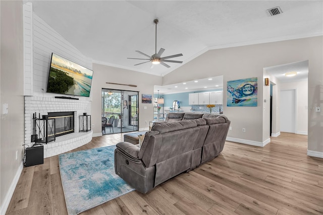 832 Birdie Way, Apollo Beach, FL 33572 - living area featuring ceiling fan, vaulted ceiling, ornamental molding, light wood-style floors, and a fireplace