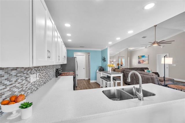 832 Birdie Way, Apollo Beach, FL 33572 - kitchen with white cabinetry, tasteful backsplash, recessed lighting, ornamental molding, and a ceiling fan