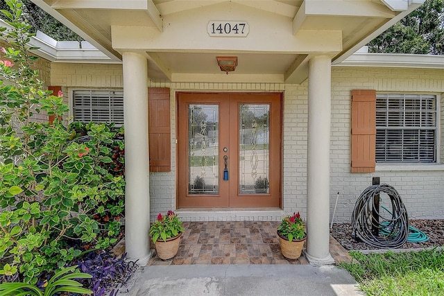 14047 Briardale Ln, Tampa, FL 33618 - doorway to property featuring brick siding and french doors