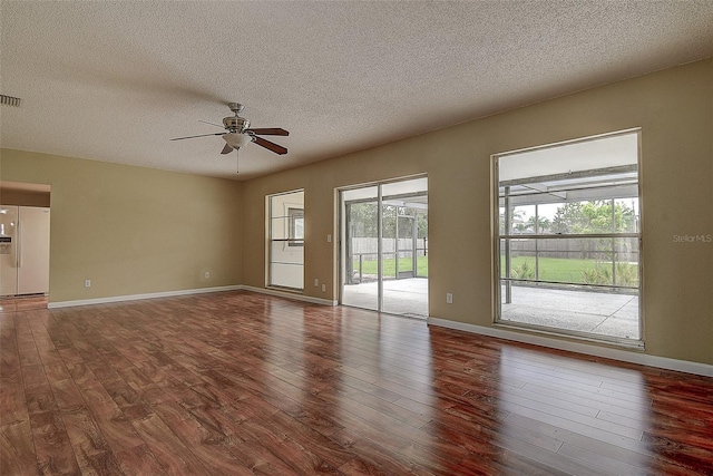 14047 Briardale Ln, Tampa, FL 33618 - empty room featuring a ceiling fan, wood finished floors, and a textured ceiling