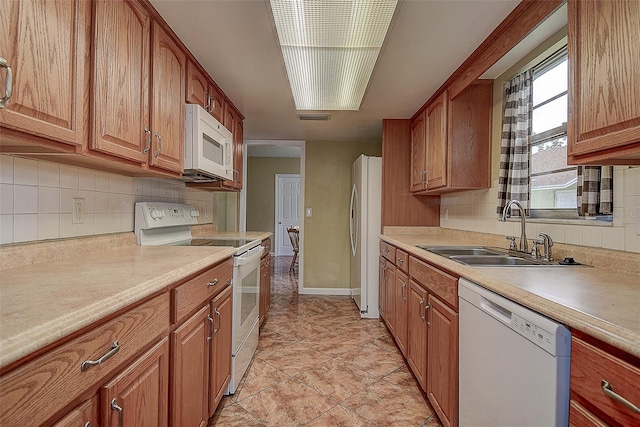 14047 Briardale Ln, Tampa, FL 33618 - kitchen with white appliances, backsplash, light countertops, and brown cabinets