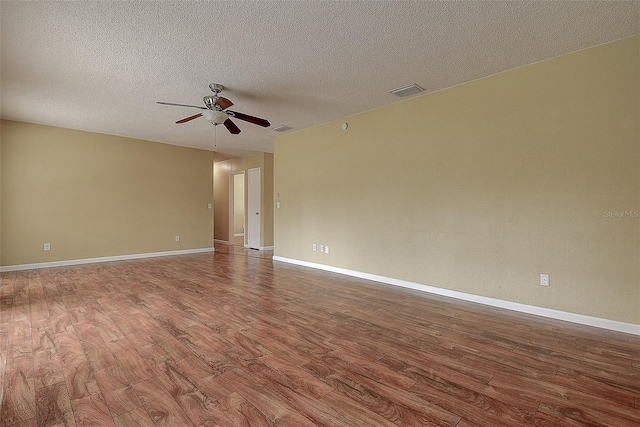 14047 Briardale Ln, Tampa, FL 33618 - unfurnished room featuring wood finished floors, a ceiling fan, and a textured ceiling
