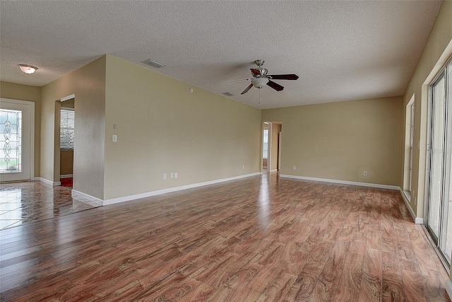 14047 Briardale Ln, Tampa, FL 33618 - spare room featuring wood finished floors, a ceiling fan, and a textured ceiling