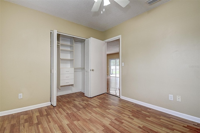 14047 Briardale Ln, Tampa, FL 33618 - unfurnished bedroom with wood finished floors, a textured ceiling, a closet, and ceiling fan