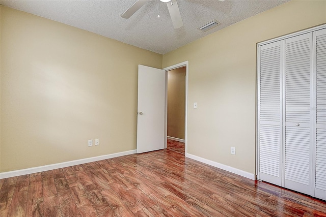 14047 Briardale Ln, Tampa, FL 33618 - unfurnished bedroom featuring wood finished floors, a closet, a textured ceiling, and a ceiling fan