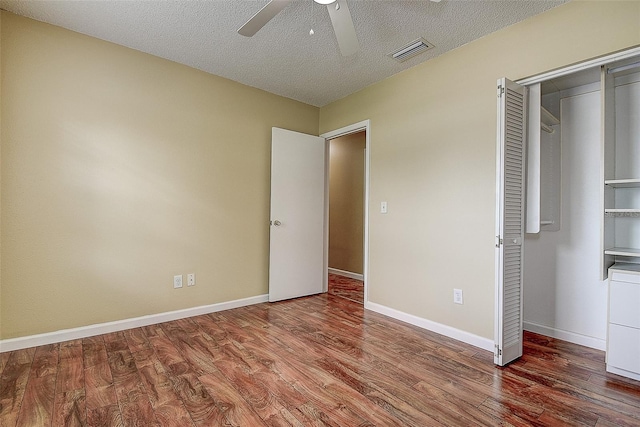 14047 Briardale Ln, Tampa, FL 33618 - unfurnished bedroom with wood finished floors, a ceiling fan, a textured ceiling, and a closet