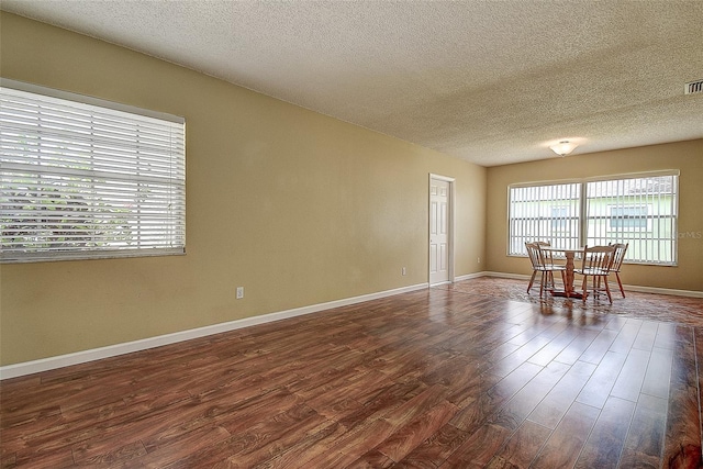 14047 Briardale Ln, Tampa, FL 33618 - spare room featuring dark wood-type flooring and a textured ceiling