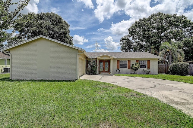 14047 Briardale Ln, Tampa, FL 33618 - view of front of house featuring a garage, concrete driveway, brick siding, and french doors