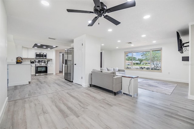 4228 Belle Isle Ct, New Port Richey, FL 34653 - living room with light wood-type flooring, ceiling fan, and recessed lighting
