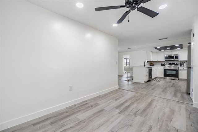 4228 Belle Isle Ct, New Port Richey, FL 34653 - unfurnished living room with light wood finished floors, a ceiling fan, and recessed lighting