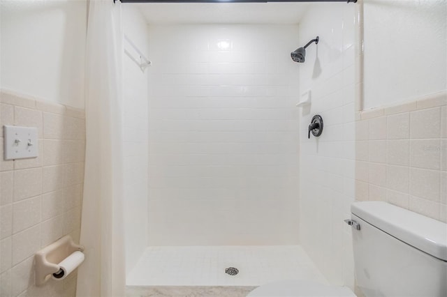 4228 Belle Isle Ct, New Port Richey, FL 34653 - bathroom with tile walls, a stall shower, and wainscoting