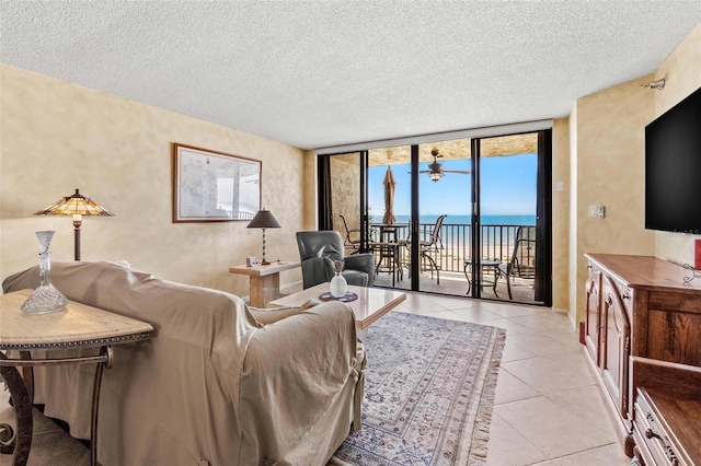 1290 Gulf Blvd Unit 702, Clearwater Beach, FL 33767 - living area with tile patterned floors, a textured ceiling, a wall of windows, and a textured wall