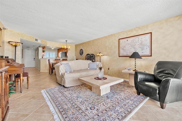 1290 Gulf Blvd Unit 702, Clearwater Beach, FL 33767 - living room with a chandelier, light tile patterned floors, and a textured ceiling