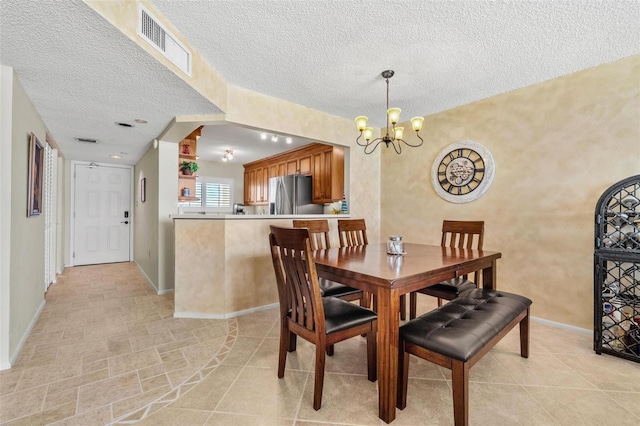 1290 Gulf Blvd Unit 702, Clearwater Beach, FL 33767 - dining area featuring a chandelier and a textured ceiling