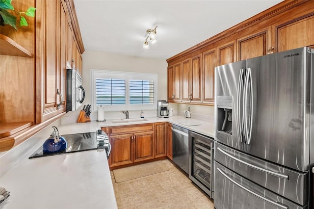 1290 Gulf Blvd Unit 702, Clearwater Beach, FL 33767 - kitchen with appliances with stainless steel finishes, beverage cooler, brown cabinets, and light countertops