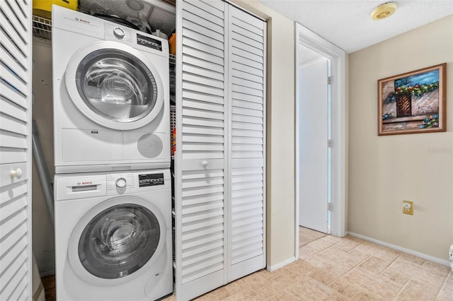 1290 Gulf Blvd Unit 702, Clearwater Beach, FL 33767 - laundry room with estacked washer and dryer and a textured ceiling