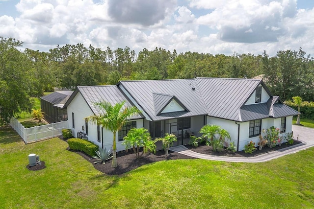 7725 235th St E, Myakka City, FL 34251 - view of front of property with a standing seam roof, a metal roof, asphalt driveway, and stucco siding