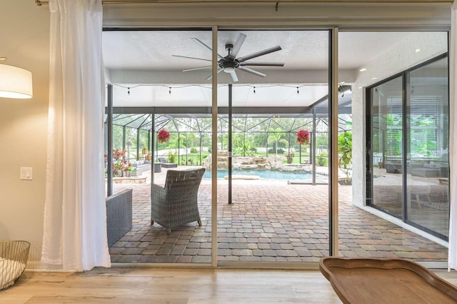 7725 235th St E, Myakka City, FL 34251 - doorway to outside with ceiling fan, a sunroom, and plenty of natural light