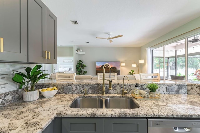 7725 235th St E, Myakka City, FL 34251 - kitchen with dishwasher, gray cabinets, a ceiling fan, light stone counters, and tasteful backsplash